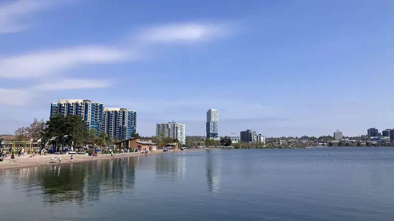 Barrie waterfront and beach on Kempenfelt Bay under a blue sky